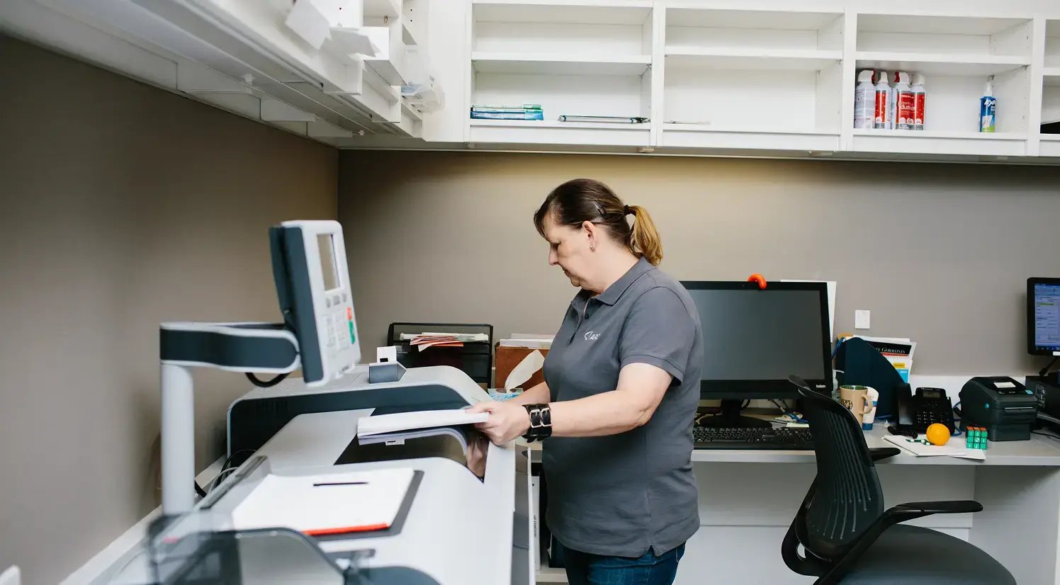 print room worker standing at printer