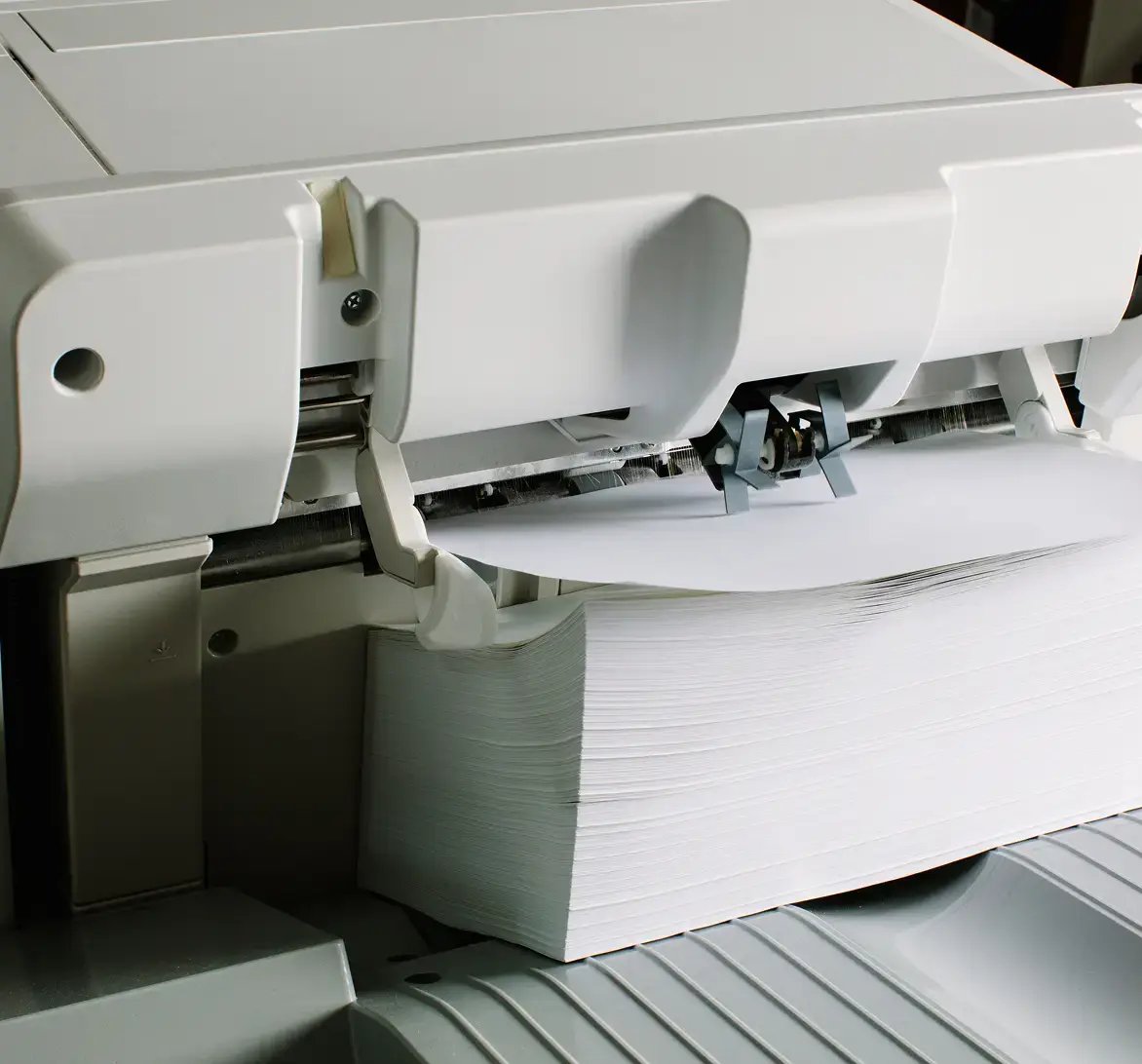 closeup of ream of printer paper loaded into printer